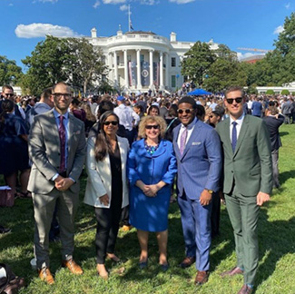 Coral with group in front of White House