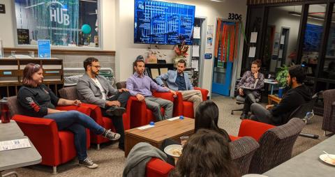 People sitting in chairs in a circle having a discussion