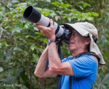 Peter E. Hart outdoors with a camera