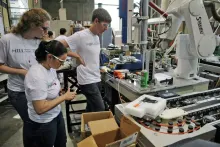 MILL students working on an assembly robot